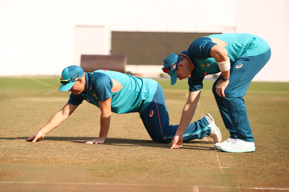 Steve Smith and David Warner check the pitch during a training session.