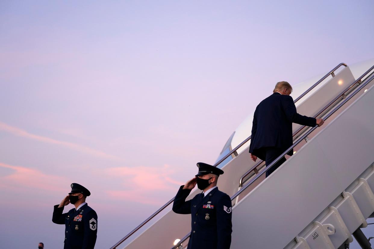 President Donald Trump boards Air Force One to travel to a campaign rally in Erie, Pennsylvania, amid a new row with 