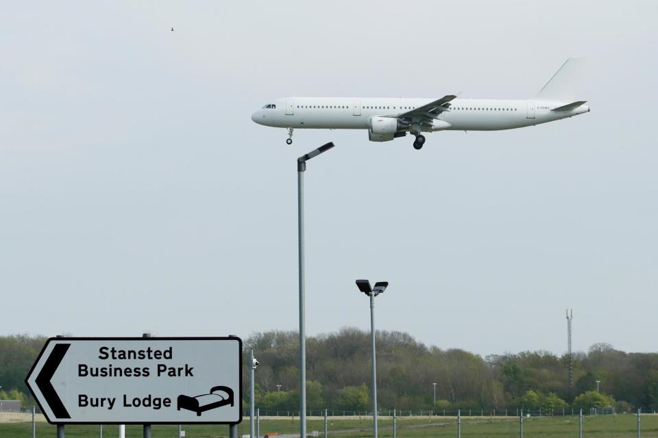 A chartered plane carrying farm workers from Romania arrives at Stansted Airport: REUTERS