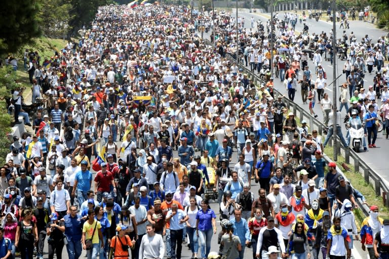 A crowd of opposition demonstrators marches through Caracas on April 26, 2017