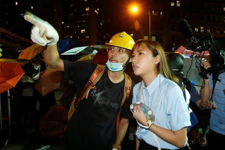Pro-independence legislator-elect Yau Wai-ching (R) talks with a protester during a confrontation with the police outside China Liaison Office in Hong Kong, China November 6, 2016. REUTERS/Bobby Yip