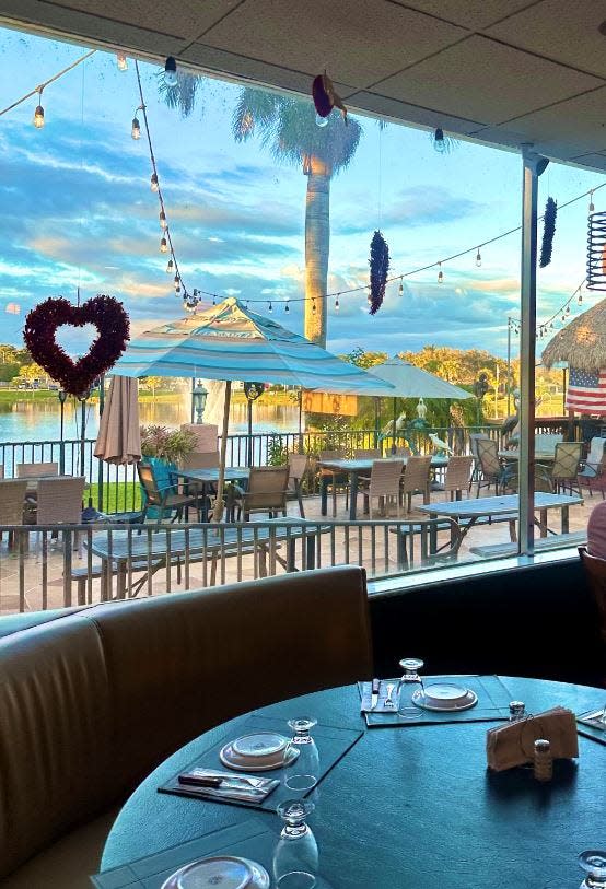 Asador Restaurant and Tiki Bar overlooks Lake Royal Palm.