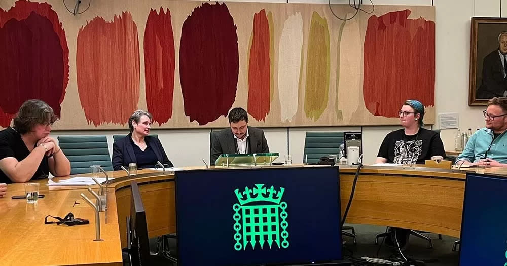 Photo of speakers sitting at table with microphones for the first UK transgender panel