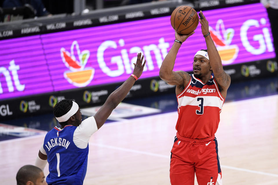 Washington Wizards guard Bradley Beal (3) shoots against Los Angeles Clippers guard Reggie Jackson (1) during the first half of an NBA basketball game, Thursday, March 4, 2021, in Washington. (AP Photo/Nick Wass)