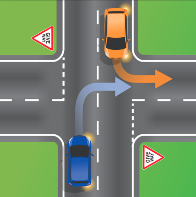 Pictured is an orange car indicating to turn left into a street while a blue car in the opposite direction indicates to turn right down the same street. 