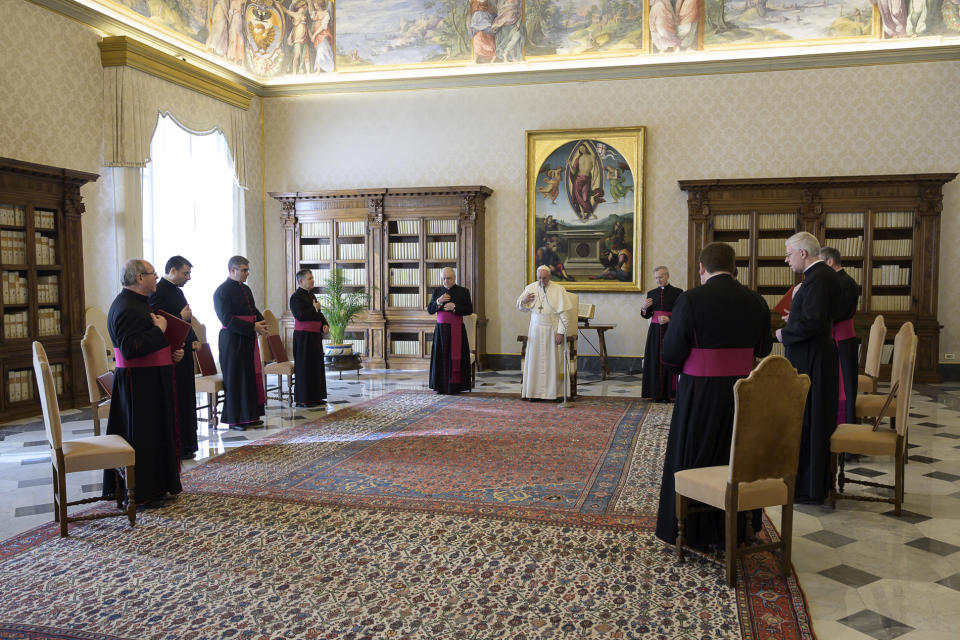 Pope Francis holds his general audience at the Vatican, Wednesday, March 11, 2020. Pope Francis held his weekly general audience in the privacy of his library as the Vatican implemented Italy’s drastic coronavirus lockdown measures, barring the general public from St. Peter’s Square and taking precautions to limit the spread of infections in the tiny city state. For most people, the new coronavirus causes only mild or moderate symptoms, such as fever and cough. For some, especially older adults and people with existing health problems, it can cause more severe illness, including pneumonia. (Vatican News via AP)