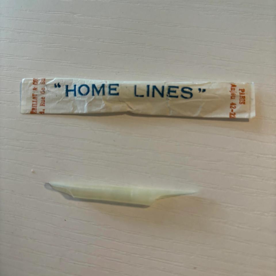 Two objects on a white surface: crumpled paper with a label 