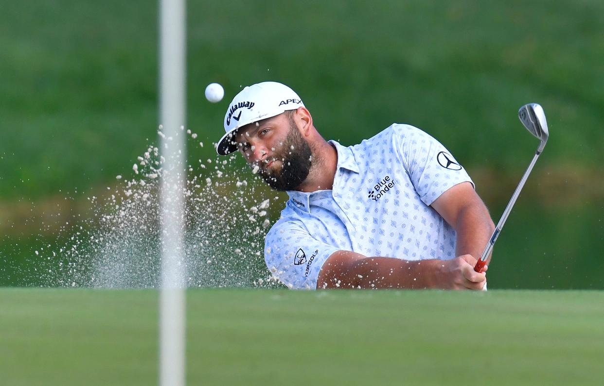 John Rahm chips from the sand to the pin on hole 12 during first round action of The Players Championship in Ponte Vedra Beach, FL, Thursday, March 9, 2023.