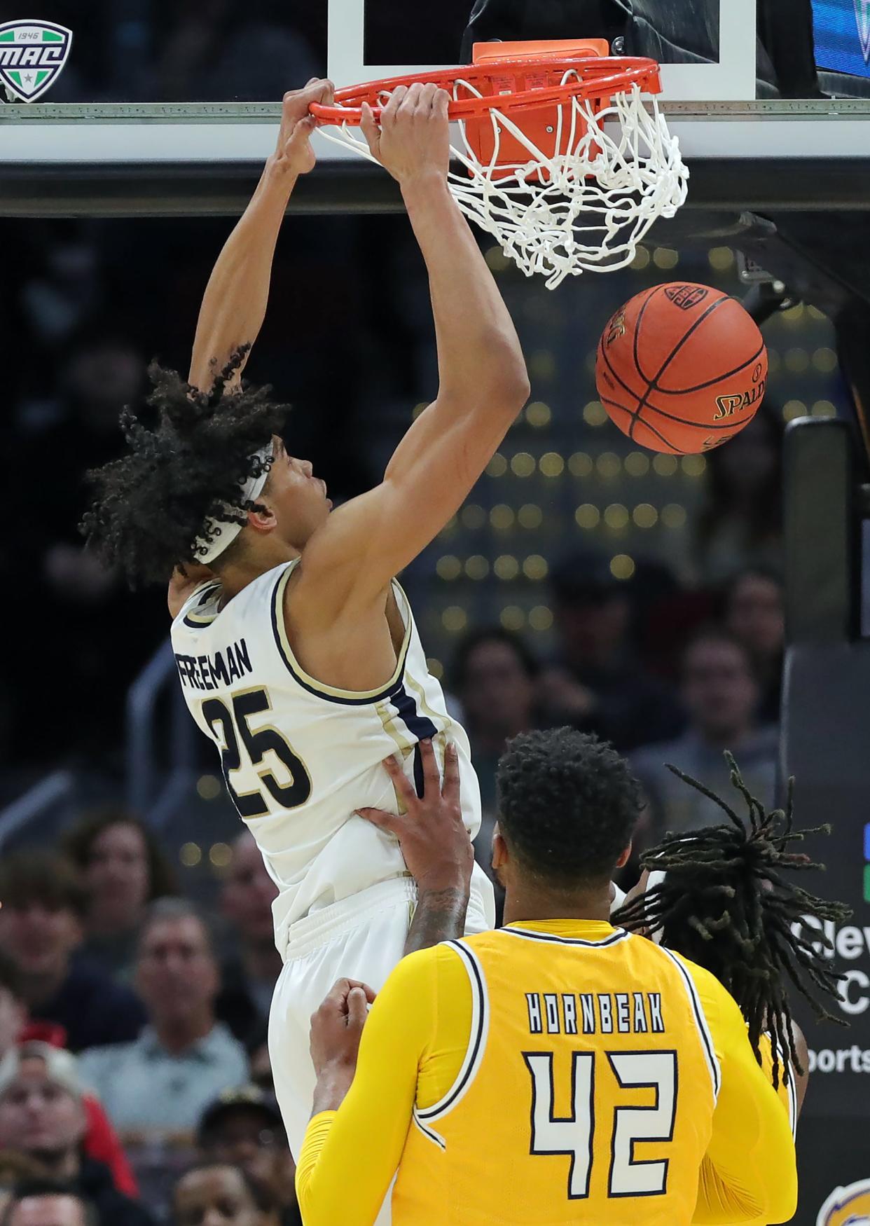 Akron Zips forward Enrique Freeman (25) dunks during the first half of the Mid-American Conference Tournament championship game at Rocket Mortgage FieldHouse, Saturday, March 16, 2024, in Cleveland, Ohio.