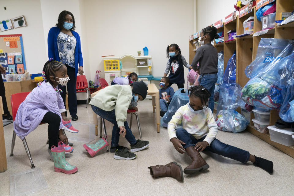 FILE - In this Wednesday, March 24, 2021, file photo, Pre-K students arrive for the school day at Phyl's Academy, in the Brooklyn borough of New York. New York City will require all of its municipal workers — including teachers and police officers — to get coronavirus vaccines by mid-September or face weekly COVID-19 testing, Mayor Bill de Blasio announced Monday, July 26, 2021. (AP Photo/Mark Lennihan, Pool, File)