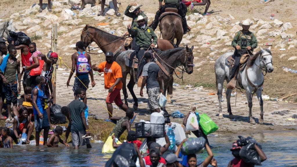 U.S. Border Patrol agents interact with Haitian immigrants, thegrio.com