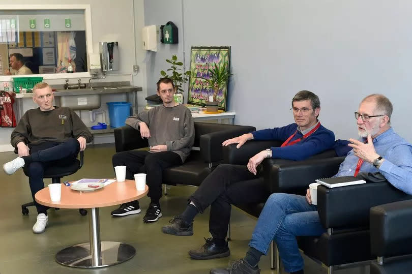 James Innes (second from right) and Charles Traylor (far right) from Men of Leith Men's Shed talk to inmates.