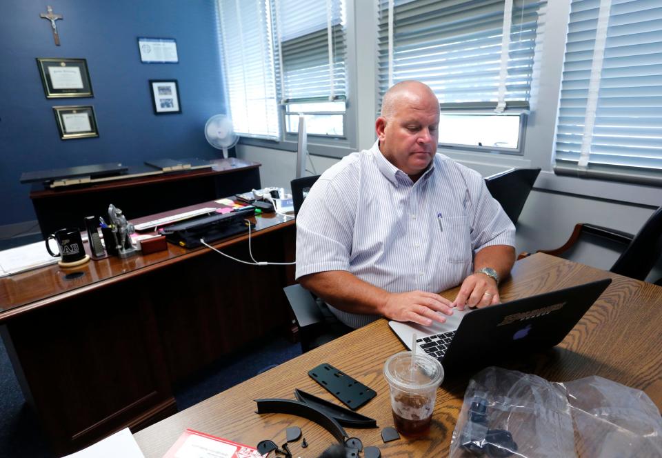 Waiting for a new desk to arrive in his office, Principal Neil Wagner prepares for the start of classes Thursday, July 21, 2016, at Central Catholic Jr./Sr. High School. Classes begin August 16, but teachers will arrive earlier to prepare their classrooms. The Lafayette Diocese, which includes Central Catholic, requires background checks of its employees every three years.
