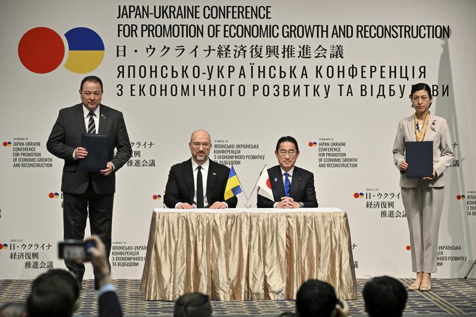 Ukraine's Prime Minister Denys Shmyhal, center left, and Japanese Prime Minister Fumio Kishida attend a cooperation exchange ceremony of a memorandum during the Japan-Ukraine Conference for Promotion of Economic Growth and Reconstruction at Keidanren Kaikan building in Tokyo, Monday, Feb. 19, 2024. (Kazuhiro Nogi/Pool Photo via AP)