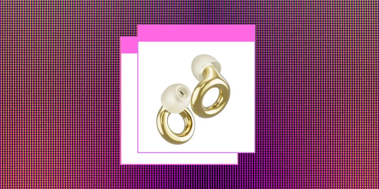 some gold loop earplugs set against a pink background