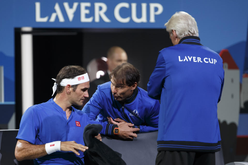 Team Europe's Rafael Nadal, center, speaks to Team Europe's Roger Federer, left, next to Team Europe's Captain, Bjorn Borg during a match against Team World's Nick Kyrgios at the Laver Cup tennis event in Geneva, Switzerland, Saturday, Sept. 21, 2019. (Salvatore Di Nolfi/Keystone via AP)