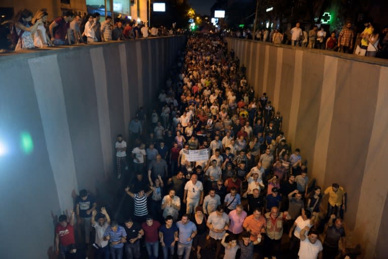 Armenian opposition supporters march along the streets to the Erebuni police station where an armed pro-opposition group has been holed up with hostages for almost two weeks