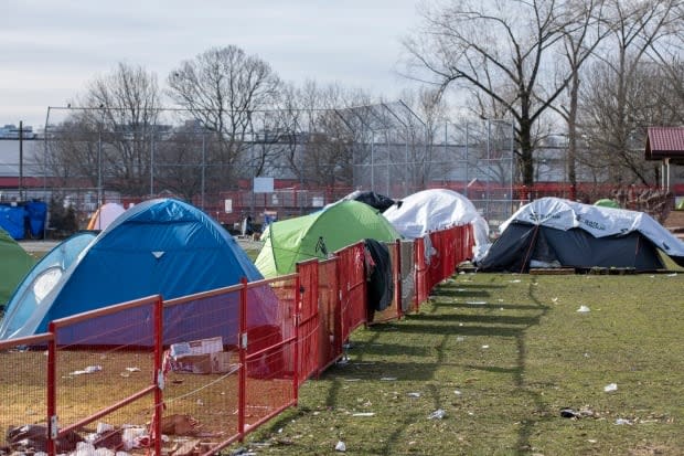 In February, a fence was installed to enclose the encampment at Strathcona Park.  (Ben Nelms/CBC - image credit)