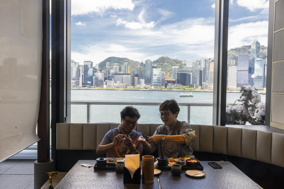 Customers eat at a sashimi restaurant in Hong Kong, Friday, July 14, 2023. As Tokyo plans to discharge treated radioactive wastewater into the sea, Hong Kong’s Japanese restaurants and seafood suppliers are bracing for a slump in business under a potential ban by Hong Kong on aquatic products from 10 Japanese regions. (AP Photo/Louise Delmotte)