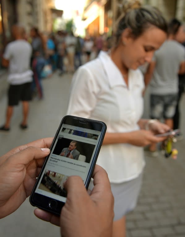 People use their mobile phone to connect to the internet in Havana