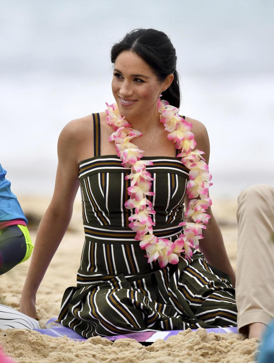 Meghan meets a local surfing community group OneWave on Bondi Beach (AP)