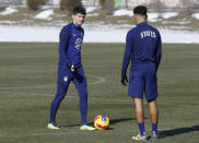 U.S. men's national team soccer forward Christian Pulisic, left, talks with midfielder Tyler Adams during practice in Columbus, Ohio, Wednesday, Jan. 26, 2022, ahead of Thursday's World Cup qualifying match against El Salvador. (AP Photo/Paul Vernon)