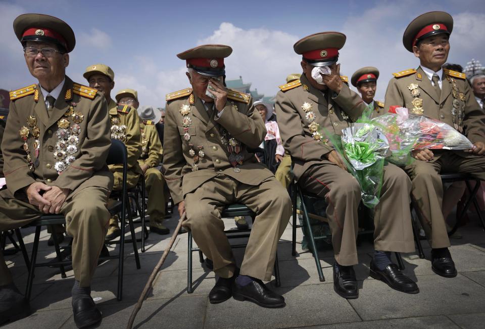 North Korean war veterans express varying degrees of emotion as they watch a parade celebrating the anniversary of the Korean War, Sunday, July 27, 2014, in Pyongyang, North Korea. North Koreans gathered at Kim Il Sung Square as part of celebrations for the 61st anniversary of the armistice that ended the Korean War. (AP Photo/Wong Maye-E)