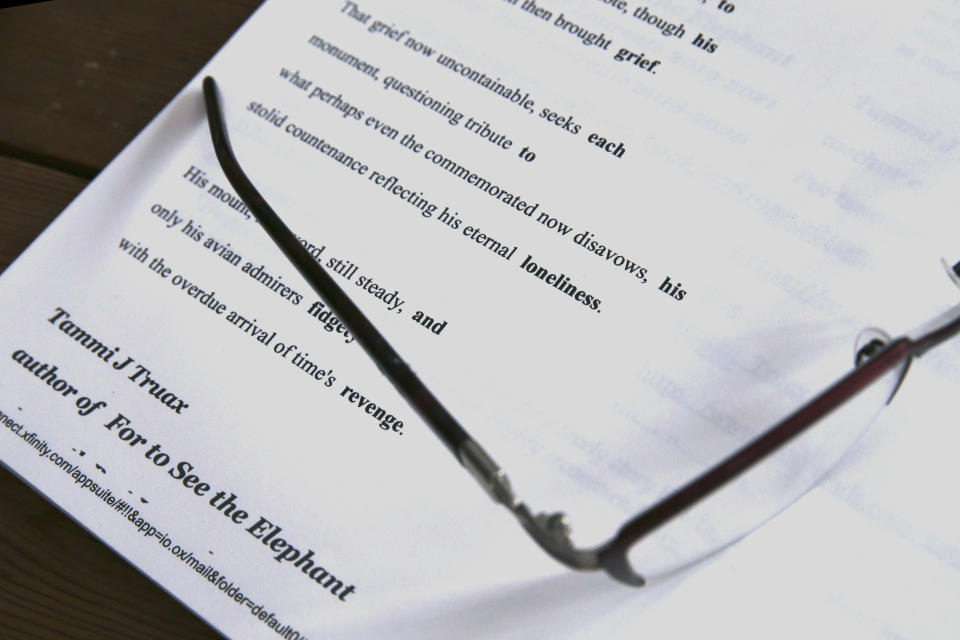 The reading glasses of poet Tammi Truax rests on a print out of one of her poems, Wednesday, July 29, 2020, at her home in Eliot, Maine. Truax, the poet laureate for Portsmouth, N.H., pens a weekly pandemic poem that is included in the city's COVID-19 newsletter. (AP Photo/Charles Krupa)