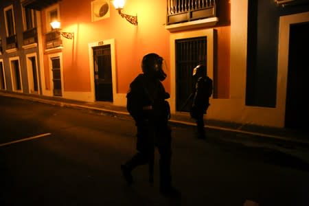 Police clash with demonstrators during a protest calling for the resignation of Governor Ricardo Rossello in San Juan