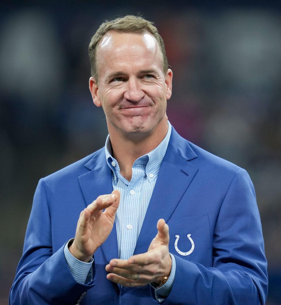 Former Indianapolis Colts quarterback Peyton Manning claps during a Ring of Honor induction ceremony for Tarik Glenn on Oct. 30, 2022, during a game against the Washington Commanders in Indianapolis.