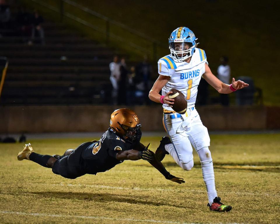Burns quarterback Ben Mauney tries to elude a Shelby tackler. Shelby won the game, 58-27, claiming the Southern Piedmont 1A/2A title in the process.