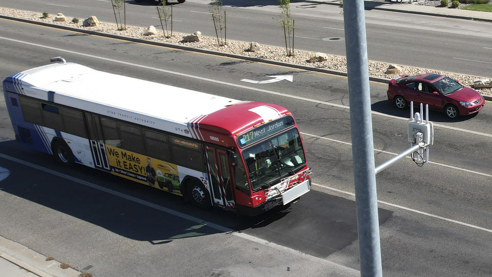 A commuter bus equipped with a radio transmitter approaches a connected traffic light on Redwood Road in Salt Lake City, part of an effort to improve safety and efficiency by allowing cars to communicate with the roadside infrastructure and one another, Friday, Sept. 6, 2024, near Taylorsville, Utah. (AP Photo/Rick Bowmer)