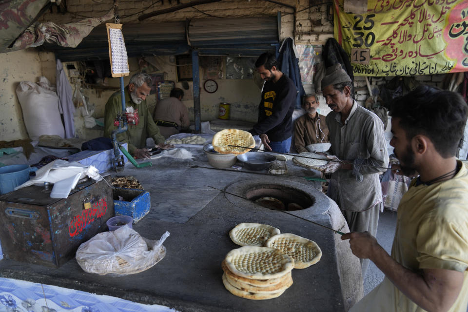 A vendor prepares bread or 'Naan' for customers at a tandoor, in Lahore, Pakistan, Tuesday, Feb. 14, 2023. Cash-strapped Pakistan nearly doubled natural gas taxes Tuesday in an effort to comply with a long-stalled financial bailout, raising concerns about the hardship that could be passed on to consumers in the impoverished south Asian country. Pakistan's move came as the country struggles with instability stemming from an economic crisis. (AP Photo/K.M. Chaudary)