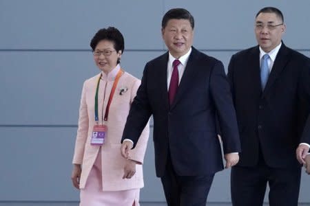 Chinese President Xi Jinping, Hong Kong Chief Executive Carrie Lam and Macau Chief Executive Fernando Chui arrive for the opening ceremony of the Hong Kong-Zhuhai-Macau bridge in Zhuhai, Guangdong province, China October 23, 2018. REUTERS/Aly Song