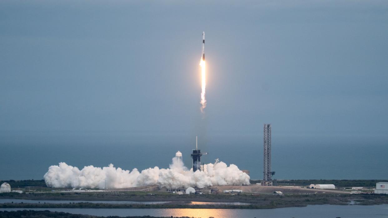  A rocket launches above a plume of smoke. 