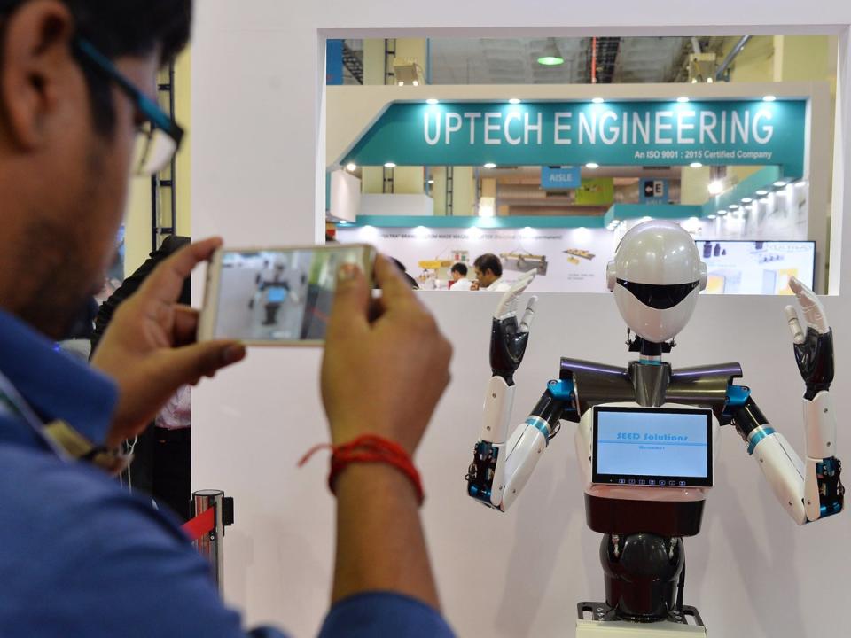 A humanoid robot gestures during a demo at a stall in the Indian Machine Tools Expo, IMTEX/Tooltech 2017 held in Bangalore (Getty)