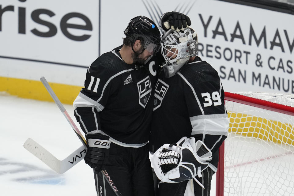 Los Angeles Kings center Anze Kopitar (11) celebrates with goaltender Cam Talbot (39) after a 4-1 win over the Anaheim Ducks in a preseason NHL hockey game Tuesday, Oct. 3, 2023, in Los Angeles. (AP Photo/Ashley Landis)