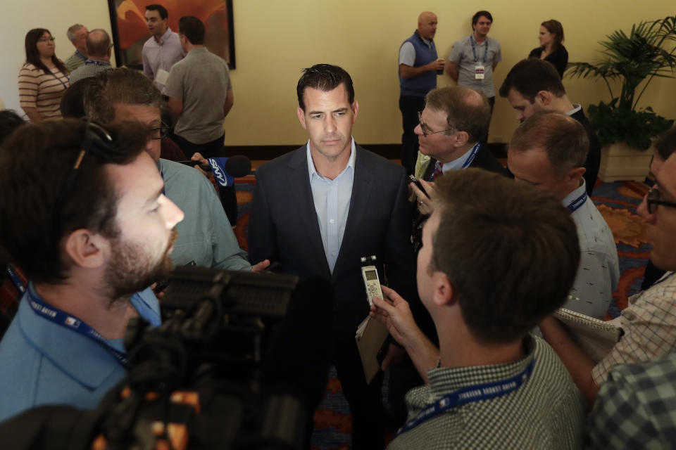 New York Mets general manager Brodie Van Wagenen, center, speaks to reporters during the baseball general managers meetings Wednesday, Nov. 7, 2018, in Carlsbad, Calif. (AP Photo/Gregory Bull)