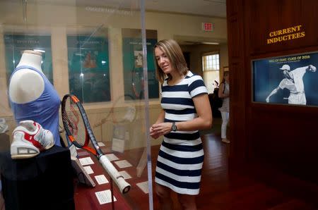 Justine Henin of Belgium looks over a display of her items in the museum before being inducted into the International Tennis Hall of Fame in Newport, Rhode Island, U.S. July 16, 2016. REUTERS/Mary Schwalm