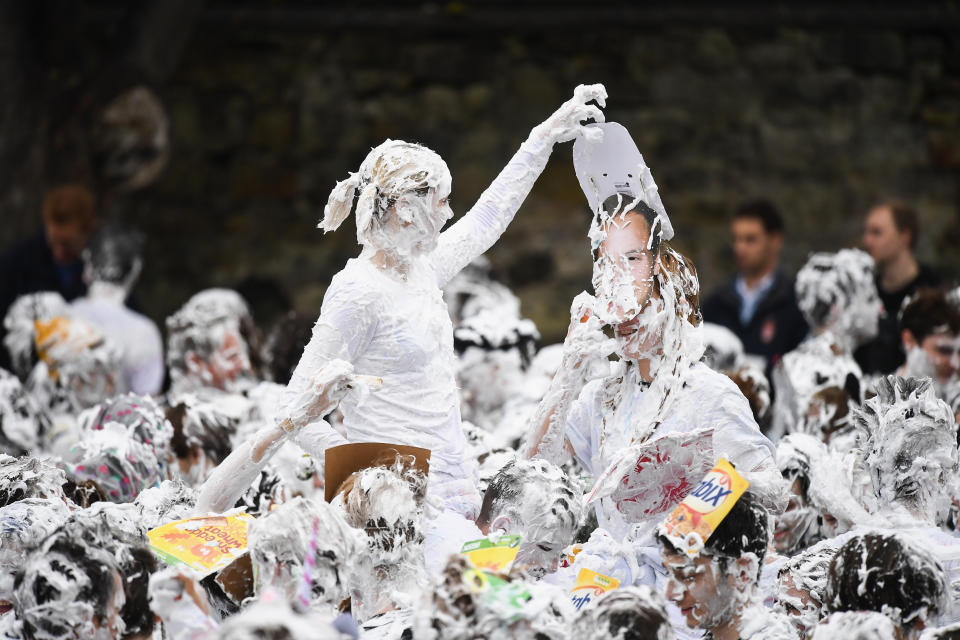 <p>Students from St Andrews University indulge in a tradition of covering themselves with foam to honor the “academic family” on Lower College Lawn on Oct. 23, 2017, in St Andrews, Scotland. (Photo: Jeff J Mitchell/Getty Images) </p>