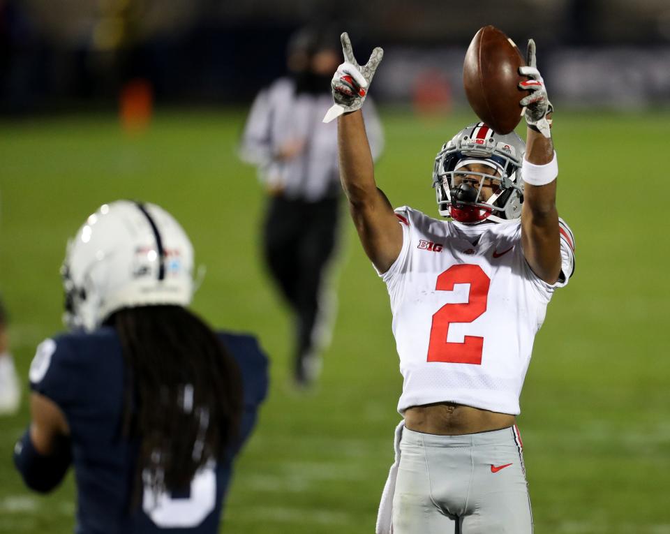 Ohio State receiver Chris Olave gestures after picking up a first down in Saturday's win at Penn State