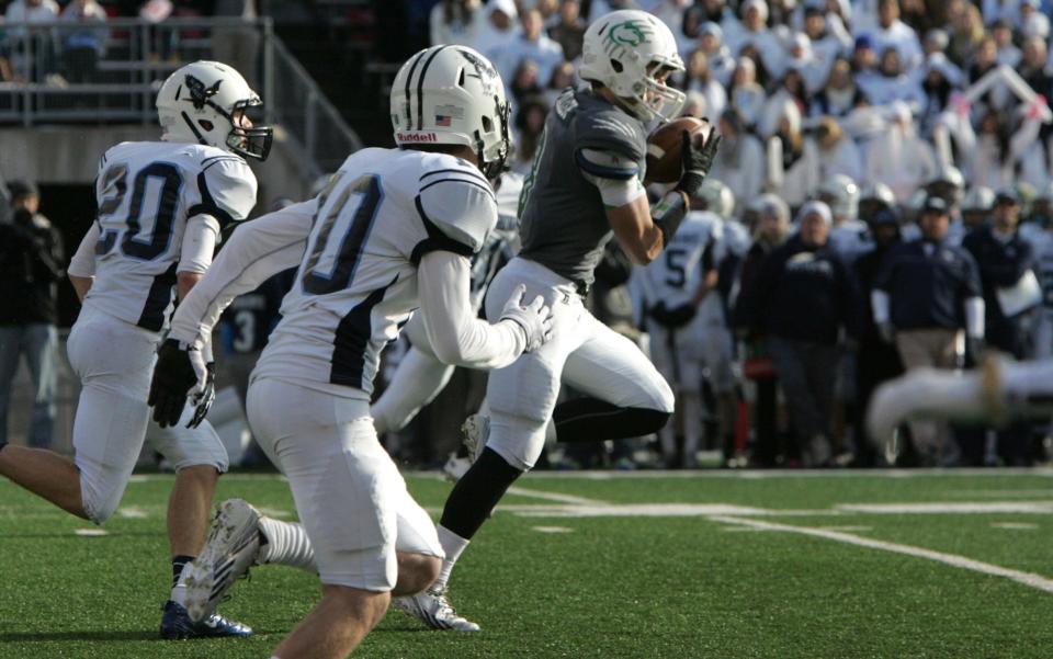 Greendale's Nate Miller breaks away from Monona Grove defenders on a reception and touchdown run at Camp Randall Stadium on Nov. 22, 2013.