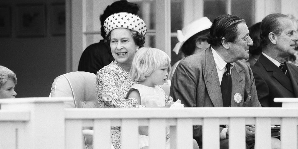 <p>Zara Phillips, daughter of Princess Anne and Captain Mark Phillips, sits on the Queen's lap during a polo match.</p>