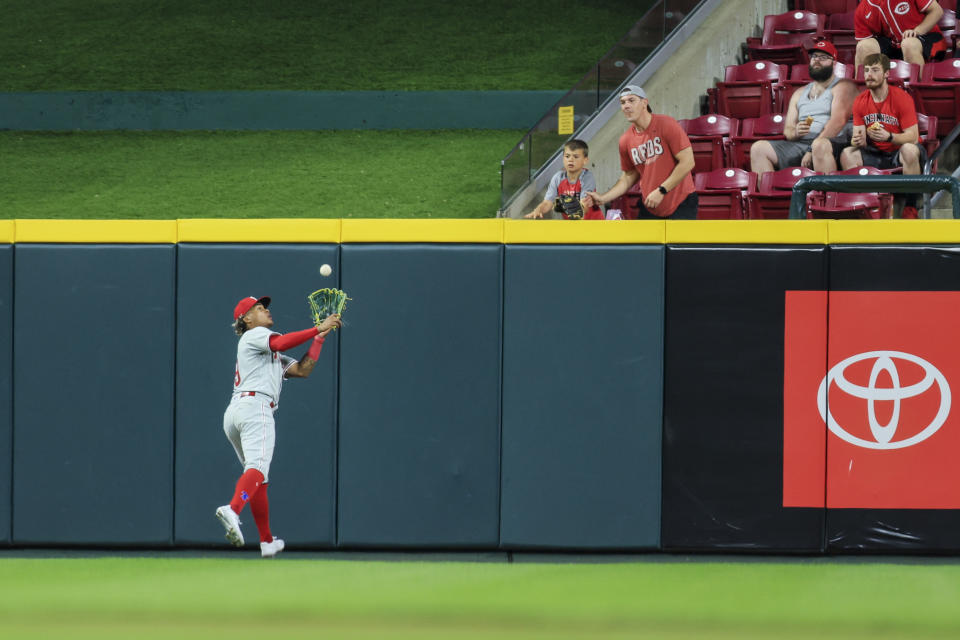 Philadelphia Phillies' Cristian Pache makes a catch for an out on a ball hit by Cincinnati Reds' Wil Myers during the eighth inning of a baseball game in Cincinnati, Thursday, April 13, 2023. (AP Photo/Aaron Doster)