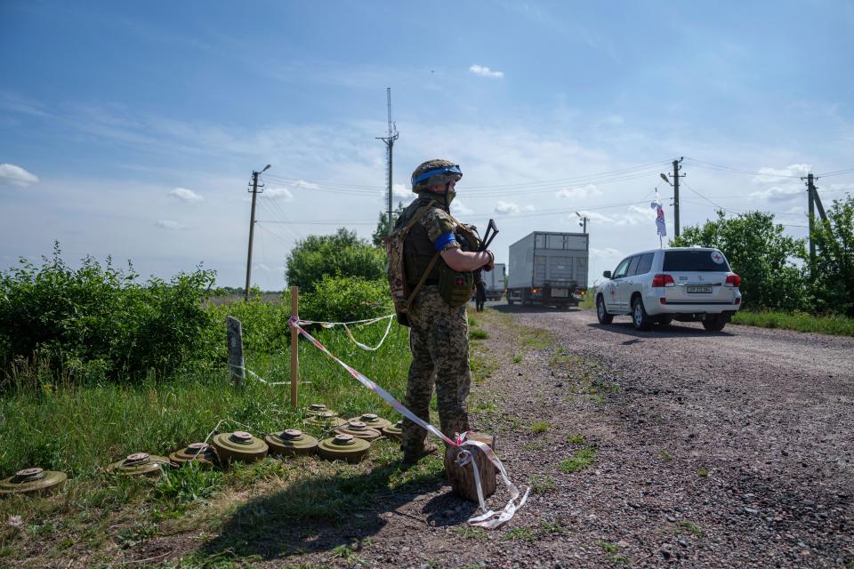 An Ukrainian soldier guards his position while trucks with killed Russian soldiers driving to Russian territory, during repatriation in Sumy region, Ukraine, Friday, 31 May 2024 (AP)