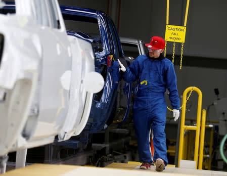 FILE PHOTO: A General Motors Co. assembly worker does quality control checks on the paint of Chevrolet 2019 heavy-duty pickup trucks in Flint