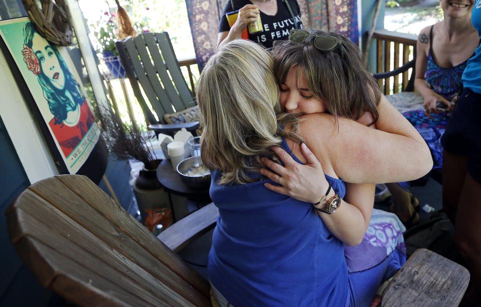 Meghan Meeker, facing, hugs Akron City Councilwoman Nancy Holland as she leaves after mourning the Supreme Court's decision to overturn Roe v. Wade on Friday.