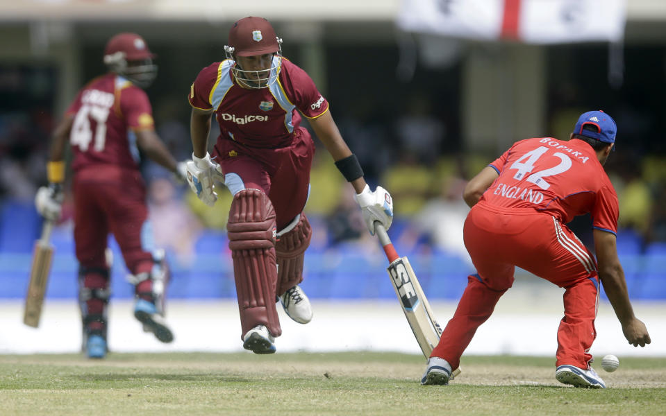 West Indies' Lendl Simmons runs as England's Ravi Bopara, right, fields during their second one-day international cricket match at the Sir Vivian Richards Cricket Ground in St. John's, Antigua, Sunday, March 2, 2014. (AP Photo/Ricardo Mazalan)