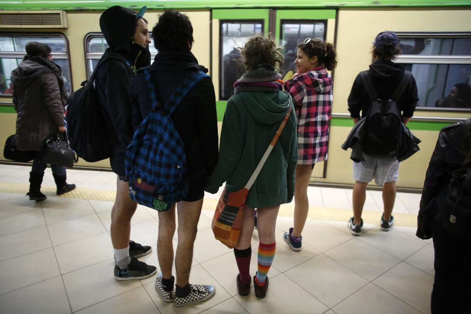 Passengers without their pants wait for a train during the "No Pants Subway Ride" event at a subway station in Sofia