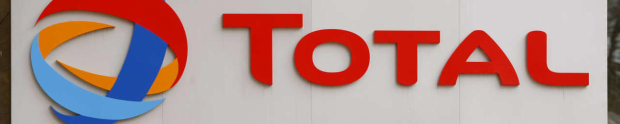 The logo of French oil giant Total is seen at its headquarters in the financial and business district of la Defense in Courbevoie near Paris October 21, 2014. The chief executive of French oil major Total, Christophe de Margerie, was killed when his private jet collided with a snow plough as it was taking off from Moscow's Vnukovo airport on Monday night.   REUTERS/Charles Platiau  (FRANCE - Tags: ENERGY BUSINESS OBITUARY LOGO)